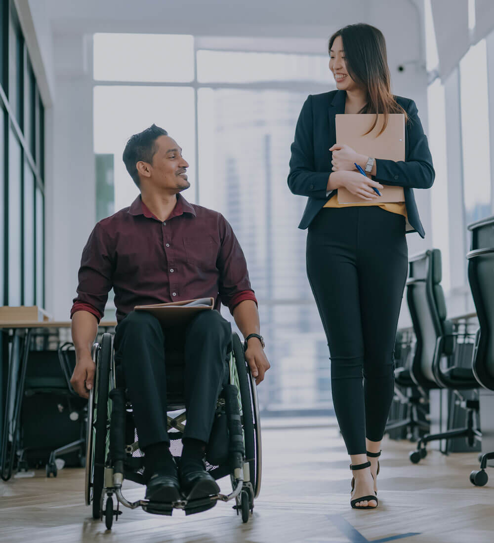 A man with a wheel chair in a corporate office